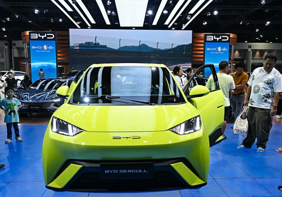 People look at a BYD Seagull car from Chinese electric vehicle (EV) manufacturer BYD Auto at the Bangkok International Motor Show in Nonthaburi on March 27, 2024. (Lillian Suwanrumpha/AFP via Getty Images)
