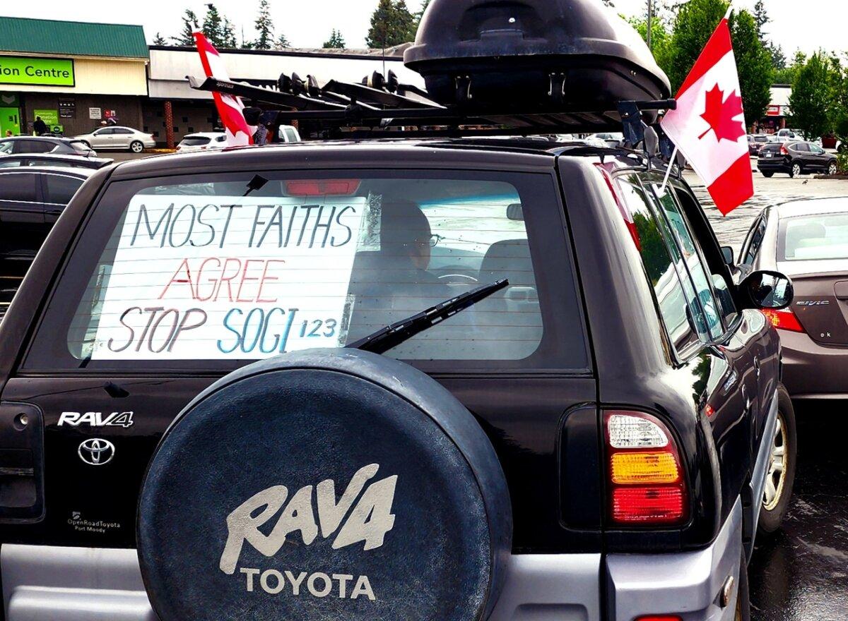 A vehicle adorned with Canadian flags and displaying a sign reading "Most faiths agree stop SOGI 123," is seen participating in a car rally held in Abbotsford, B.C., on June 1, 2024. The event opposes gender ideology curriculums in schools. (The Epoch Times)