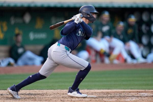 Josh Rojas of the Mariners watches his fourth-inning RBI single against the A's in Oakland, Calif., on June 4, 2024. (Jeff Chiu/AP Photo)