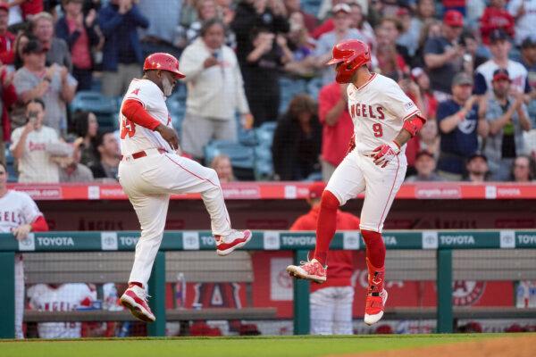 Zach Neto (R) celebrates a home run against the Brewers with Angels third-base coach Eric Young in Anaheim, Calif., on June 17, 2024. (Ryan Sun/AP Photo)