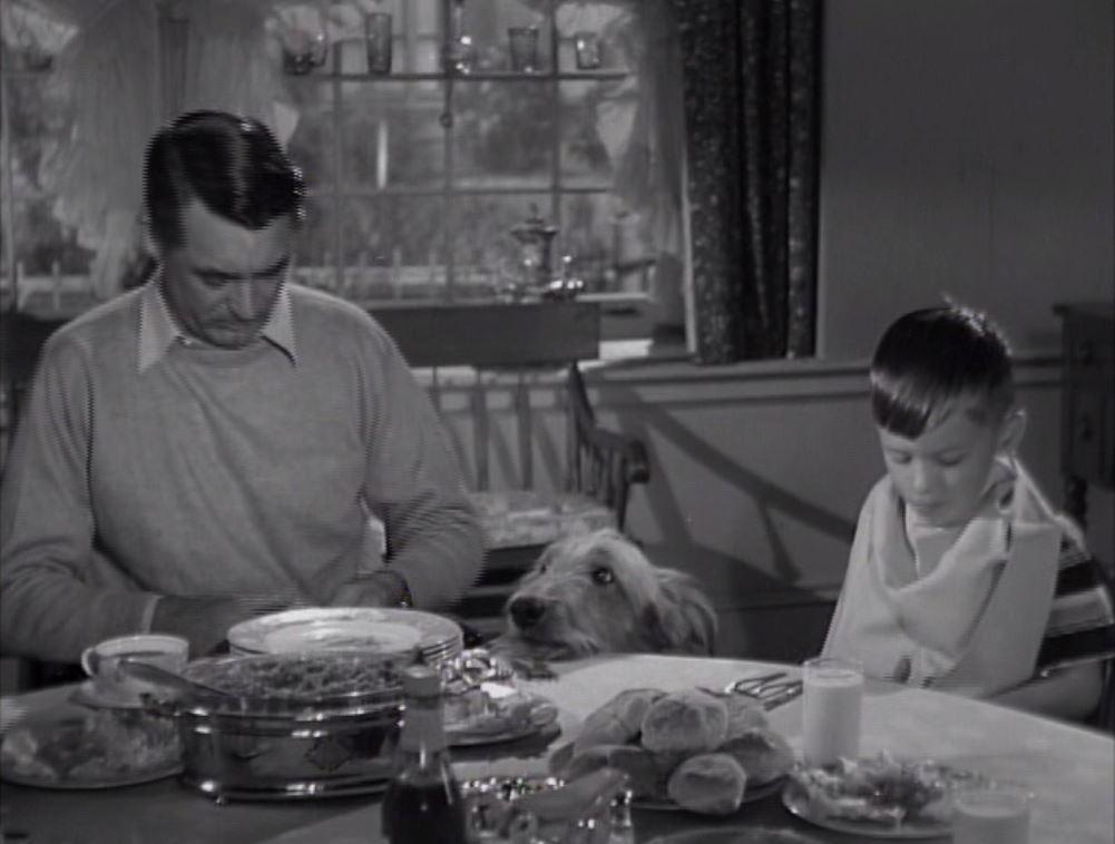 George Rose (Cary Grant) and Teenie (George Winslow) sit down for a meal, in "Room for One More." (Warner Bros.)