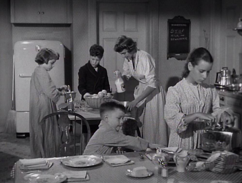 The Rose family prepares breakfast, in "Room for One More." (Warner Bros.)
