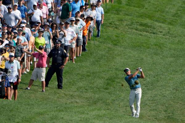 Rickie Fowler makes his approach shot on the first hole during the opening round of the Travelers Championship in Cromwell, Conn., on June 20, 2024. (Seth Wenig/AP Photo)