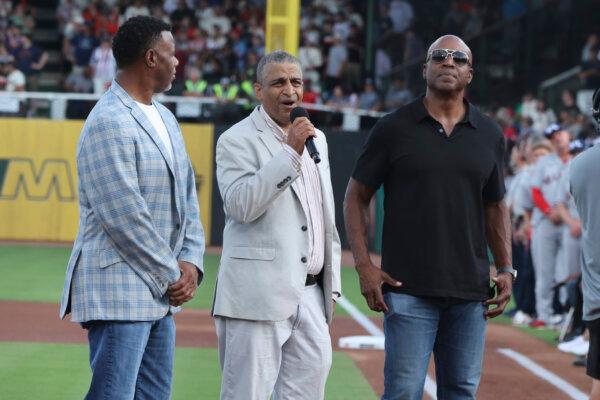Flanked by former Major League Baseball stars Ken Griffey Jr., (L) and Barry Bonds, Michael Mays, son of the late Willie Mays, honors his father before a game between the San Francisco Giants and St. Louis Cardinals at historic Rickwood Field in Birmingham, Ala., on June 20, 2024. (Vasha Hunt/AP Photo)