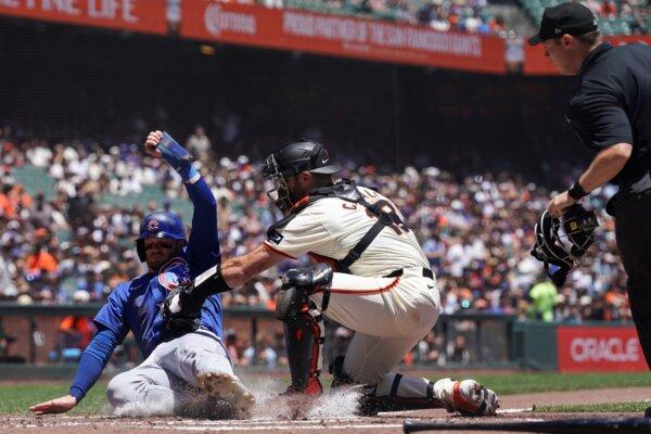 Giants catcher Curt Casali tags out the Cubs' Ian Happ at the plate during the second inning in San Francisco on June 27, 2024. (Kavin Mistry/AP Photo)