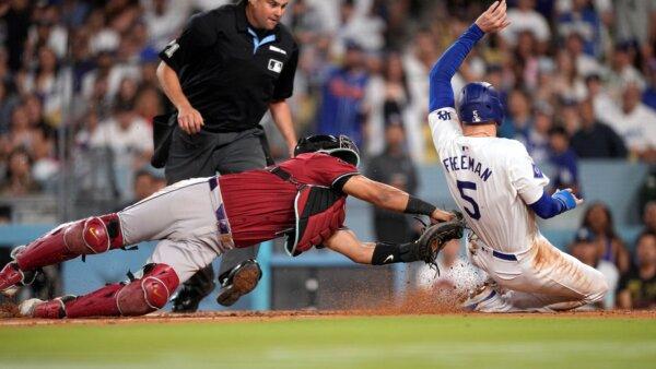 Diamondbacks catcher Gabriel Moreno lunges to tag out the Dodgers' Freddie Freeman trying to score on a lineout by Miguel Rojas in Los Angeles on July 3, 2024. (Mark J. Terrill/AP Photo)