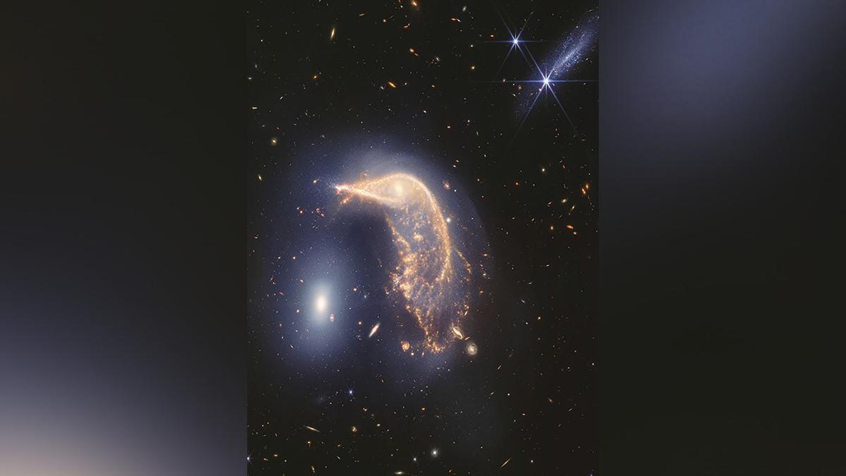 Webb Space Telescope’s Latest Cosmic Shot Shows Pair of Intertwined Galaxies Glowing in Infrared