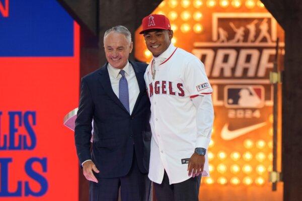 Tennessee second baseman Christian Moore (R), the eighth overall pick by the Los Angeles Angels in the Major League Baseball amateur draft, poses with Commissioner Rob Manfred in Fort Worth, Texas, on July 14, 2024. (LM Otero/AP Photo)