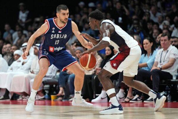 Anthony Edwards (R) of the U.S. drives against Serbia during an exhibition basketball game in Abu Dhabi, United Arab Emirates, on July 17, 2024. (Altaf Qadri/AP Photo)