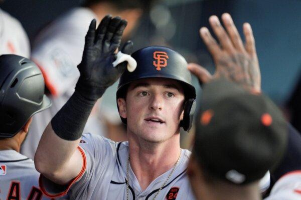 Rookie Tyler Fitzgerald accepts a high-five in the Giants dugout after hitting a home run against the Dodgers in Los Angeles on July 23, 2024. (Marcio Jose Sanchez/AP Photo)