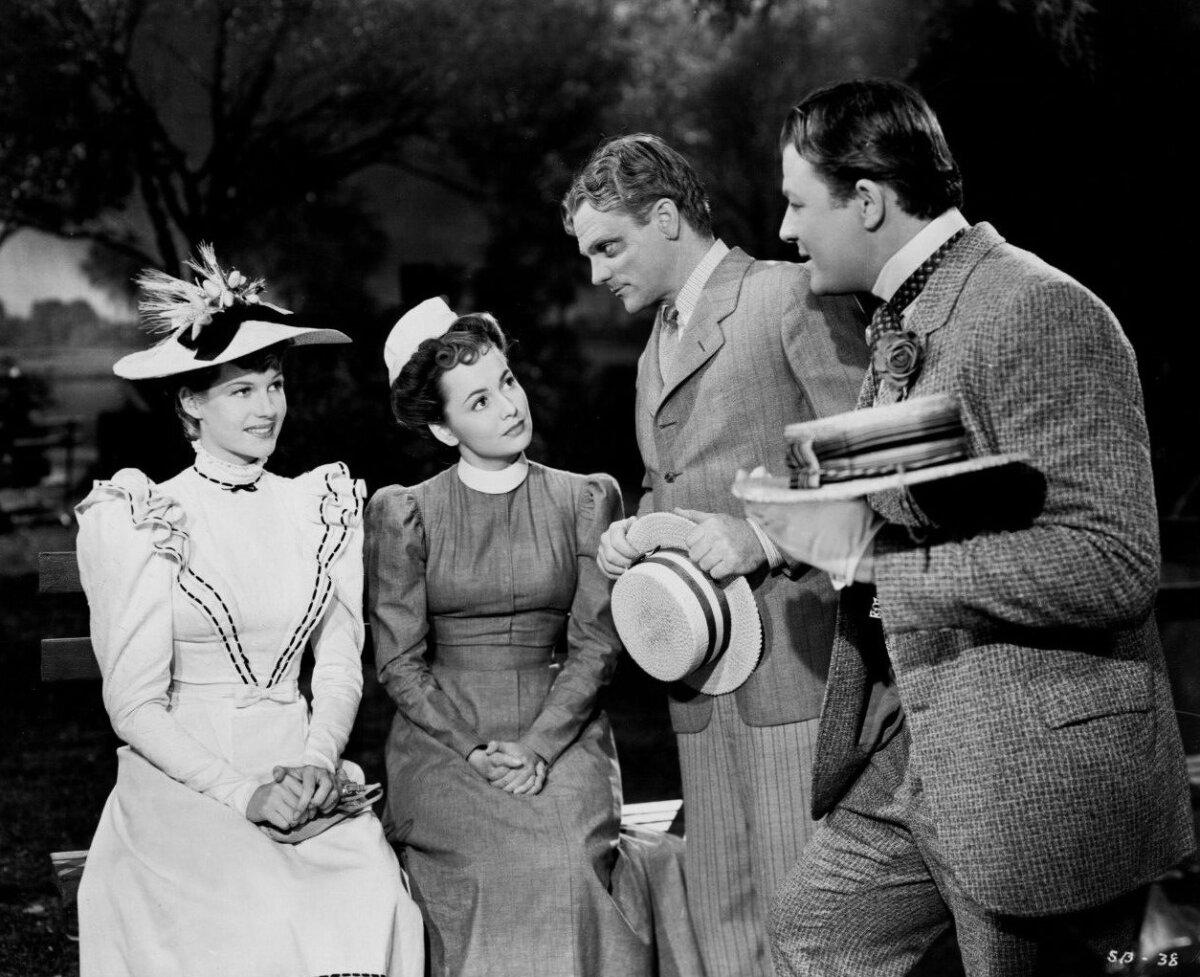 (L–R) Virginia Bush (Rita Hayworth), Amy Lind (Olivia de Havilland), Biff Grimes (James Cagney), and Hugo Barnstead (Jack Carson), in “The Strawberry Blonde.” (MovieStillsDB)