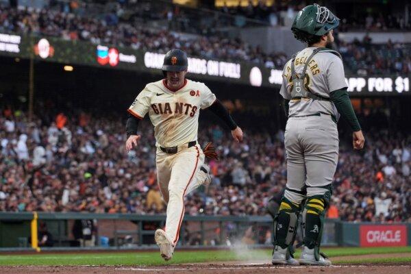 Giants right fielder Mike Yastrzemski scores the game's only run on Brett Wisely's fifth-inning sacrifice fly against the A's in San Francisco on July 31, 2024. (Godofredo A. Vásquez/AP Photo)