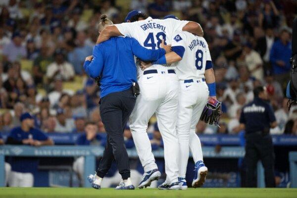 Dodgers reliever Brusdar Graterol (C) is helped off the field after being injured during a game against the Phillies in Los Angeles on Aug. 6, 2024. (Kyusung Gong/AP Photo)