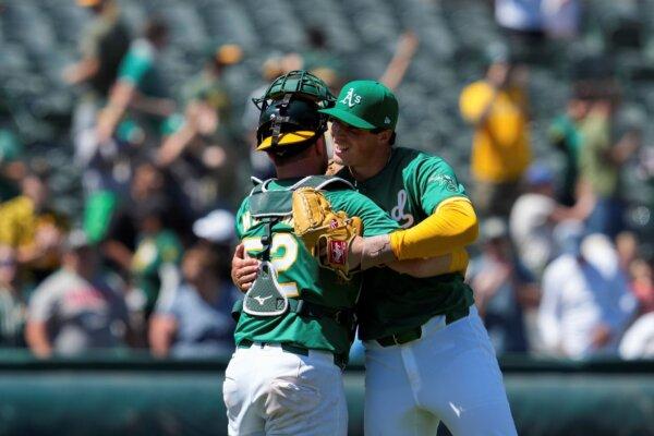 A's closer Mason Miller (R), just off the injured list, celebrates with catcher Kyle McCann after nailing down a victory over the White Sox in Oakland, Calif., on Aug. 7, 2024. (Godofredo A. Vásquez/AP Photo)