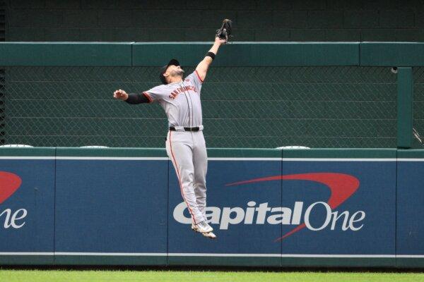 Giants left fielder Michael Conforto makes a leaping catch at the wall of a seventh-inning drive by the Nationals' Ildemaro Vargas in Washington on Aug. 8, 2024. (Nick Wass/AP Photo)
