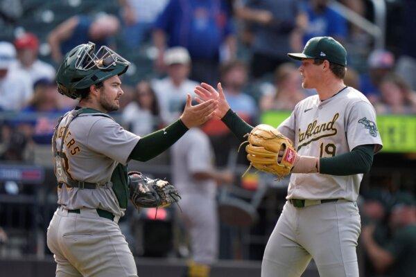 A's closer Mason Miller (R) and catcher Shea Langeliers shake hands after completing a victory over the Mets in New York on Aug. 15, 2024. (Frank Franklin II/AP Photo)