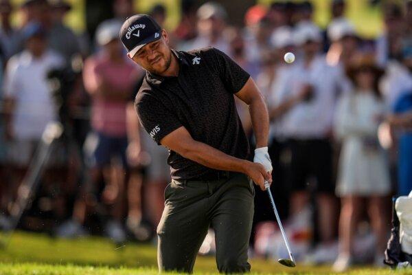 Xander Schauffele chips to the 18th green during the first round of the Tour Championship in Atlanta on Aug. 29, 2024. (Mike Stewart/AP Photo)