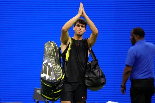 Carlos Alcaraz gestures to fans after losing to Botic van de Zandschulp, in a second-round U.S. Open match in New York on Aug. 29, 2024. (Frank Franklin II/AP Photo)