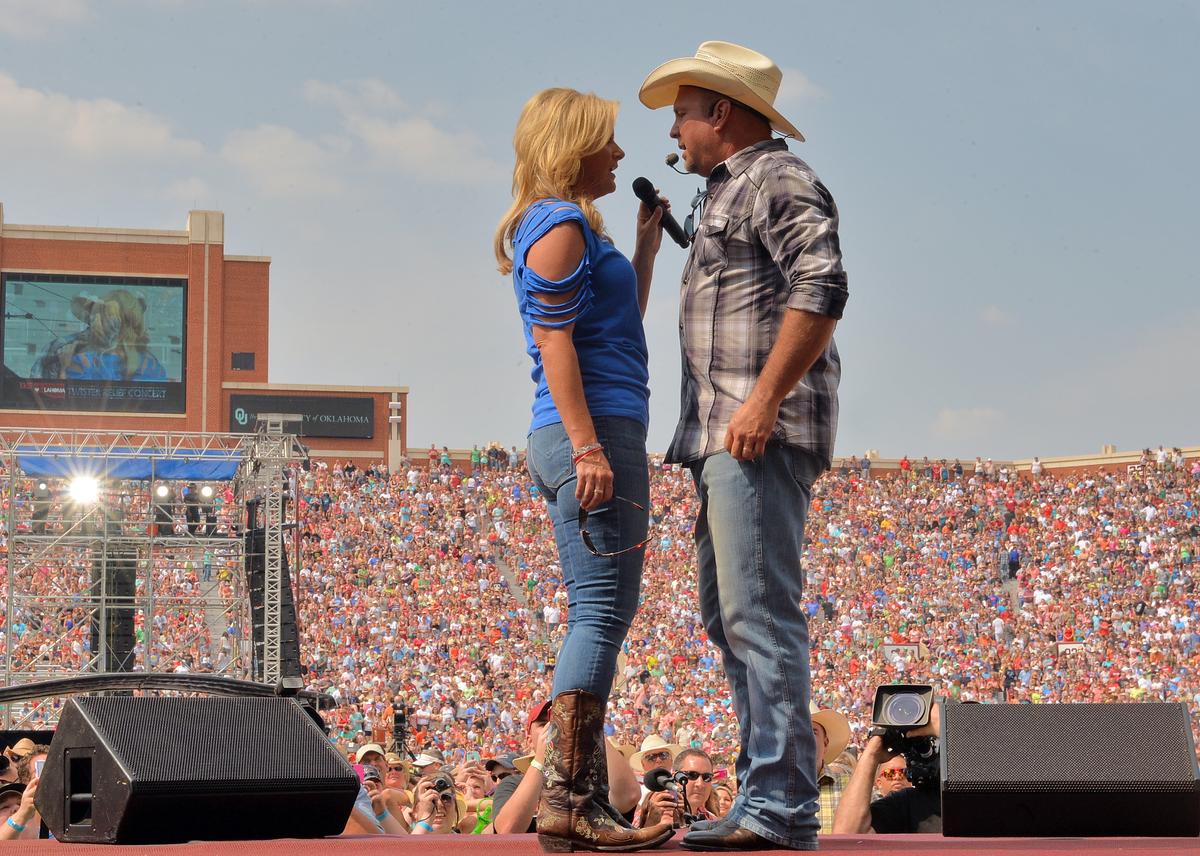 Trisha Yearwood and Garth Brooks performing together at the Gaylord Family Oklahoma Memorial Stadium on July 6, 2013, in Oklahoma. (Rick Diamond/Getty Images)