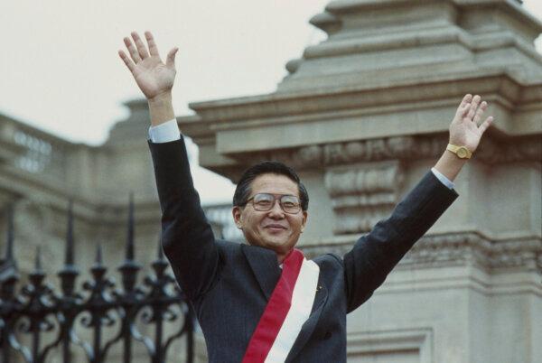 Peruvian President Alberto Fujimori waves to supporters at the Government Palace in Lima, on July 28, 1990. (Alejandro Balaguer/AP Photo)