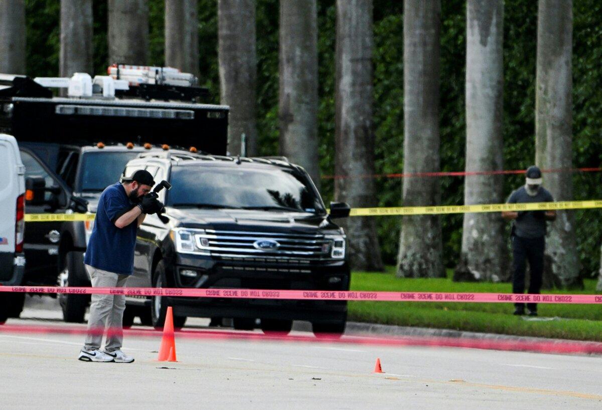 An FBI agent takes picture of the evidence of the crime scene outside the Trump International Golf Club in West Palm Beach, Florida, on Sept. 15, 2024 following a shooting incident at former president Donald Trump's golf course. (Chandan Khanna/AFP via Getty Images)