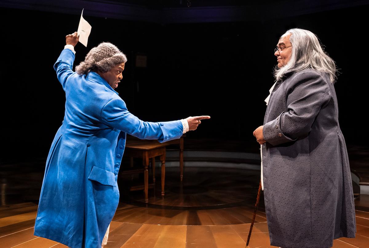 John Adams (Tyrick Wiltez Jones) has a spirited discussion with Benjamin Franklin (William R. Henry), in "1776." (Liz Lauren)
