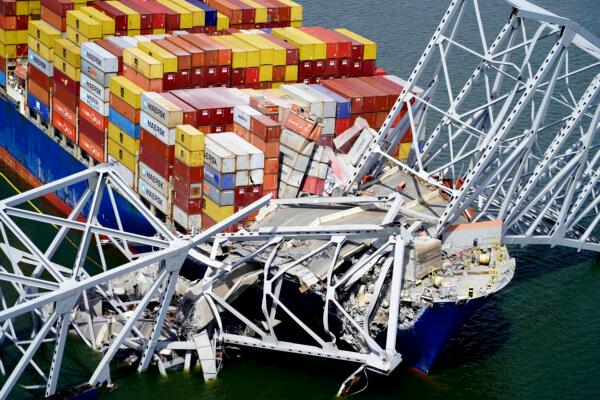 Cargo ship Dali under part of the structure of the Francis Scott Key Bridge after it hit the bridge in Baltimore, on March 26, 2024. (Maryland National Guard via AP)