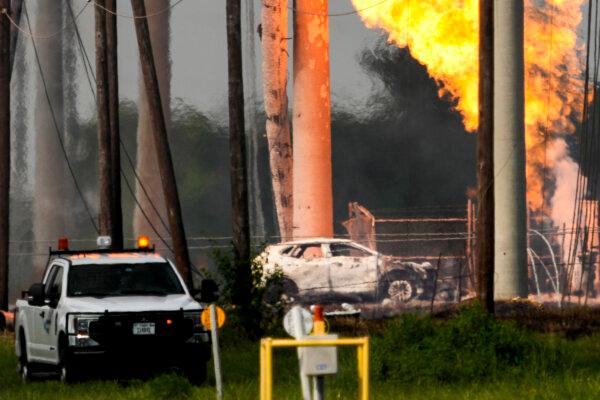 A massive pipeline fire burns after a vehicle drove through a fence along a parking lot and struck an above-ground valve near Spencer Highway and Summerton in La Porte, Texas on Sept. 16, 2024. (Brett Coomer/Houston Chronicle via AP)