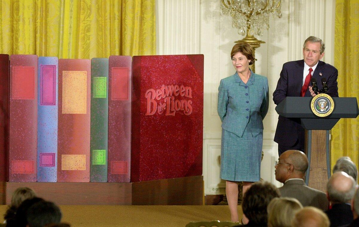 Former President George W. Bush and first lady Laura Bush promote early reading for children in the East Room of the White House on April 3, 2002. (Mike Theiler/Getty Images)