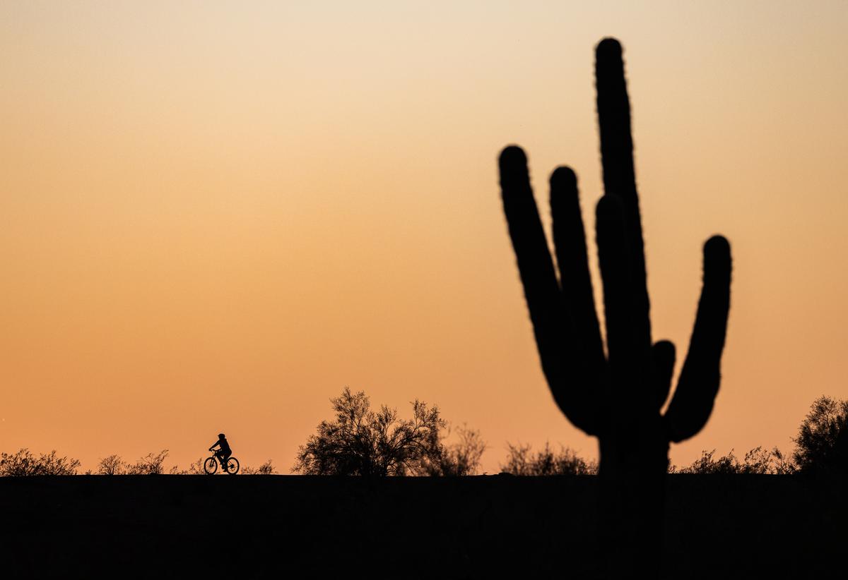 A cyclist enjoying the sunset in Phoenix on Oct. 14, 2024. (John Fredricks/The Epoch Times)