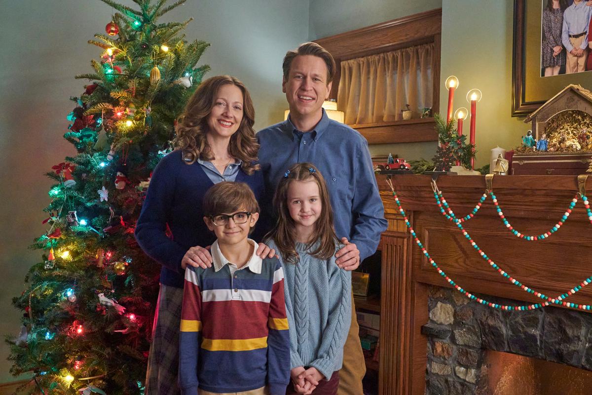 Grace (Judy Greer), Charlie (Sebastian Billingsley-Rodriguez), Beth (Molly Wright), and Bob (Pete Holmes) pose for a family photo in "The Best Christmas Pageant Ever." (Courtesy of Lionsgate)