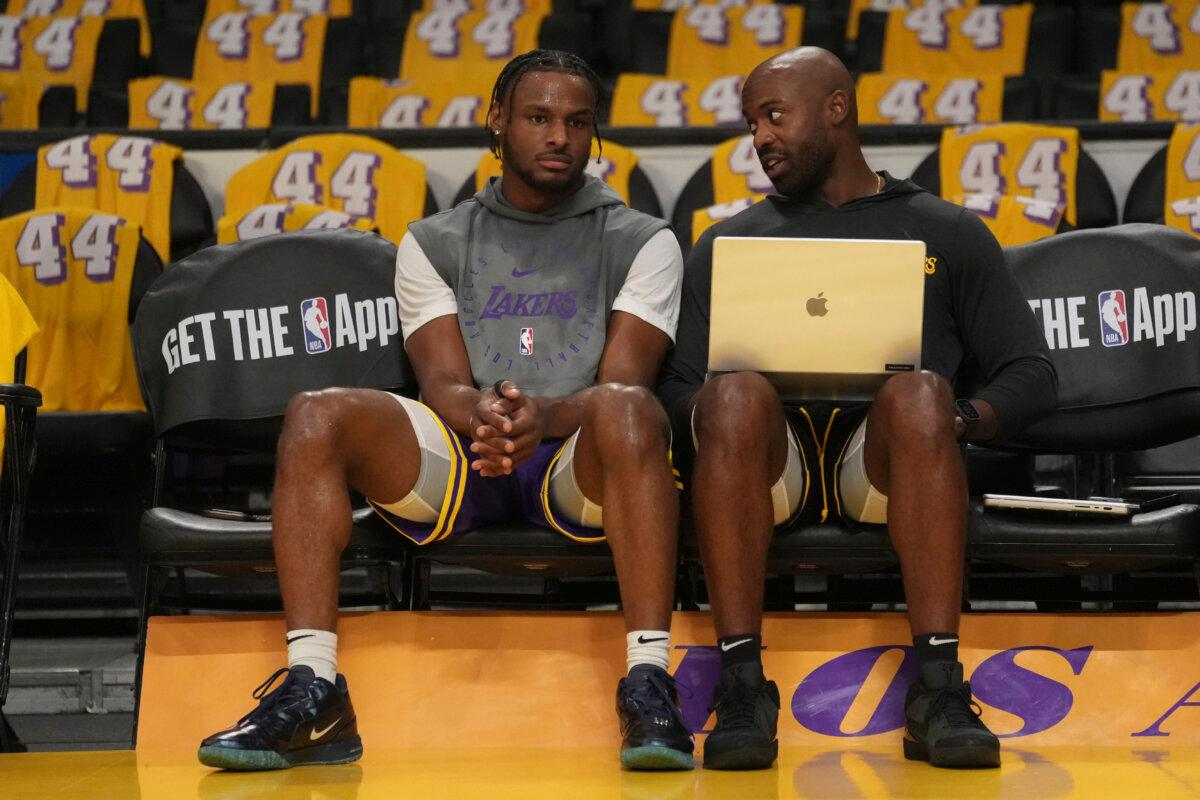 Los Angeles Lakers guard Bronny James (L) sits with a team member before an NBA basketball game against the Minnesota Timberwolves in Los Angeles on Oct. 22, 2024. (Eric Thayer/AP Photo)