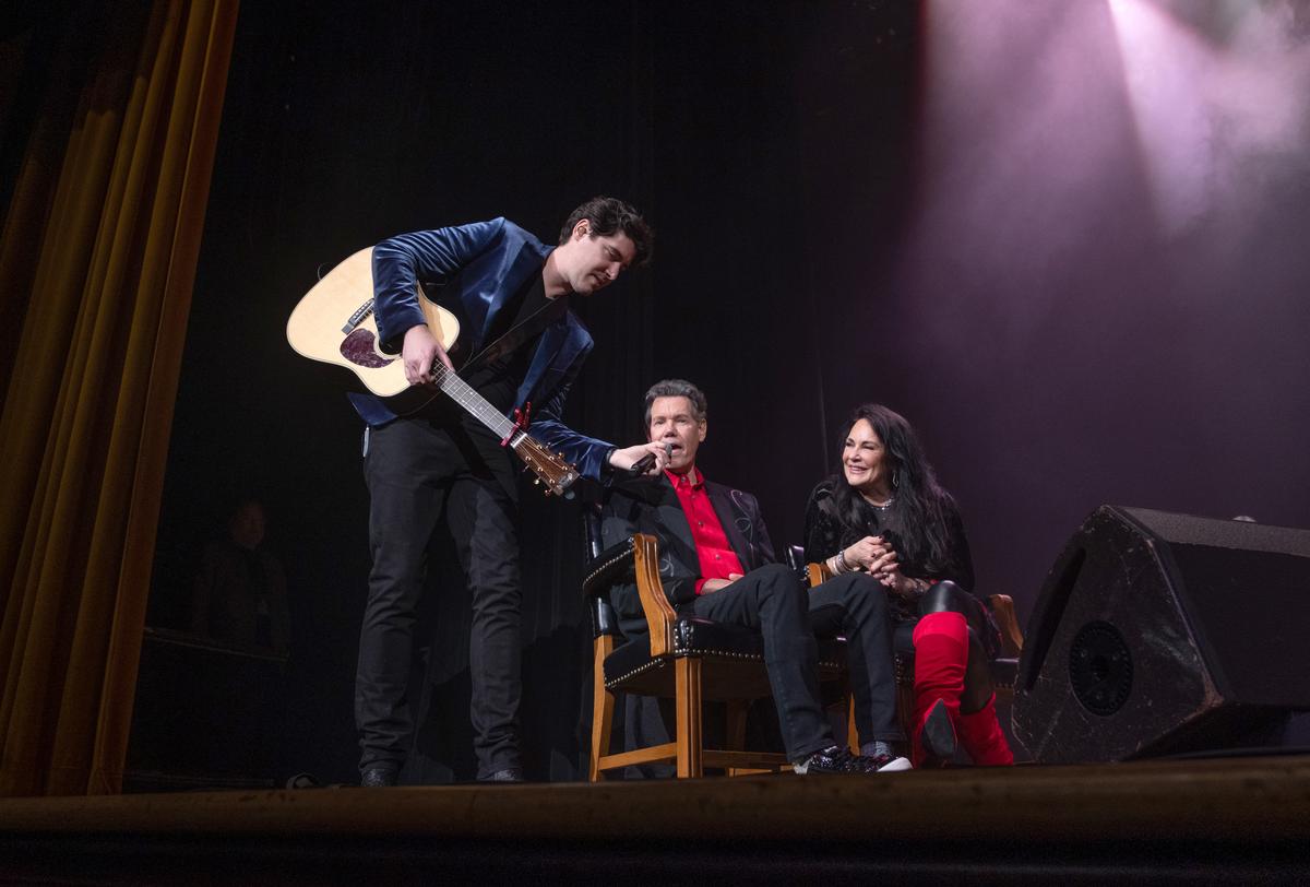 James Dupre, Randy Travis, and Mary Travis onstage at the Ryman Auditorium in Nashville, Tenn. (Jason Kempin/Getty Images)
