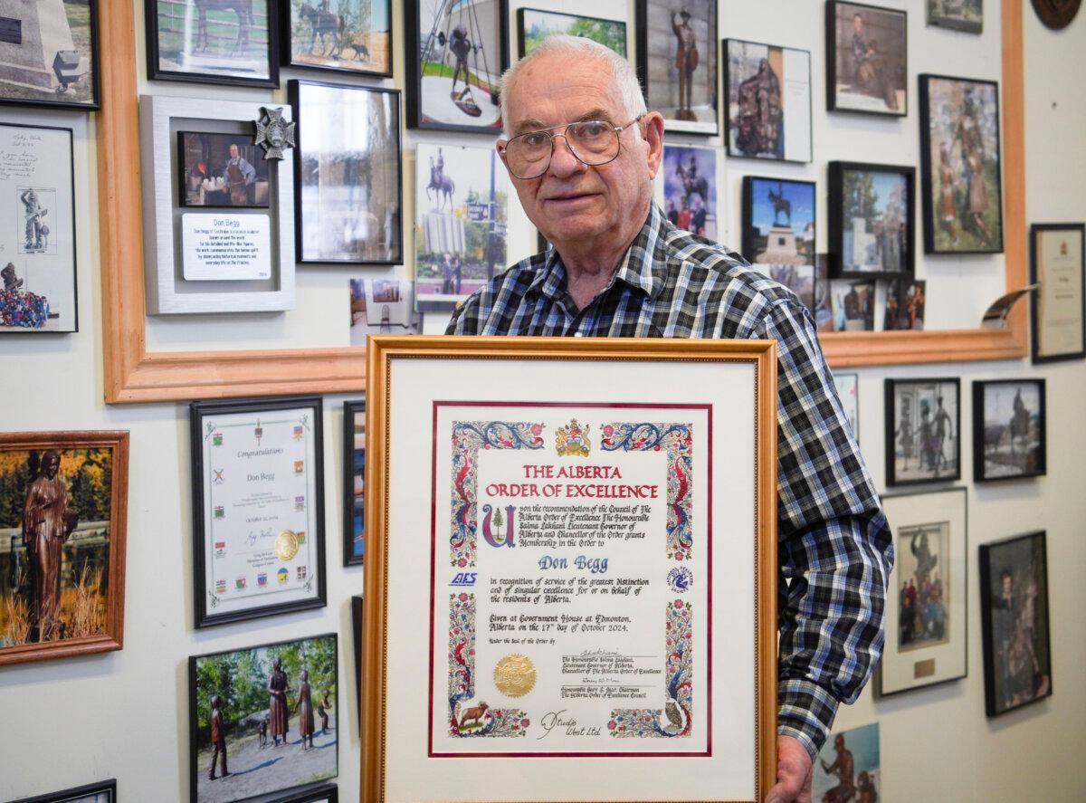 Bronze sculptor Don Begg holds a certificate of the Alberta Order of Excellence, awarded to him this year, at Studio West Bronze Foundry & Art Gallery in Cochrane, Alta., on Nov. 22, 2024. (Carolina Avendano/The Epoch Times)