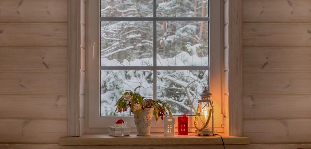Candlelight in windows is a welcoming touch during the winter. (Olga Ionina/Shutterstock)