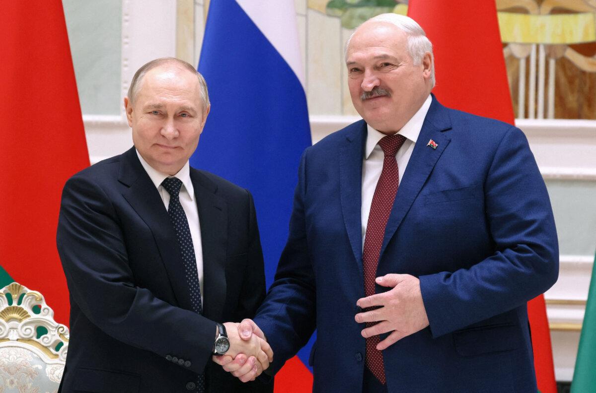 Russian President Vladimir Putin and Belarusian President Alexander Lukashenko shake hands at a press briefing in Minsk, Belarus, on May 24, 2024. (Mikhail Metzel/Sputnik/pool via Reuters)