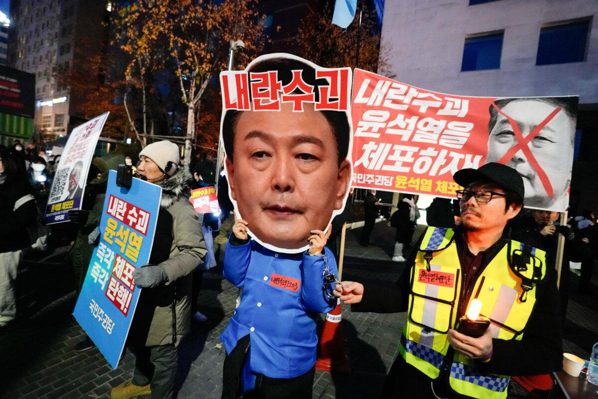 A participant wearing a mask of South Korean President Yoon Suk Yeol attends a rally demanding his impeachment, outside the National Assembly in Seoul, South Korea, on Dec. 8, 2024. (Ahn Young-joon/AP)