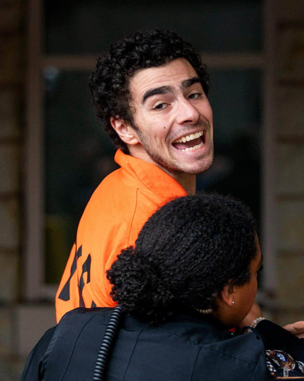 Day in Photos: Shooting Suspect, Malibu Wildfire, and a Swimming Santa Claus