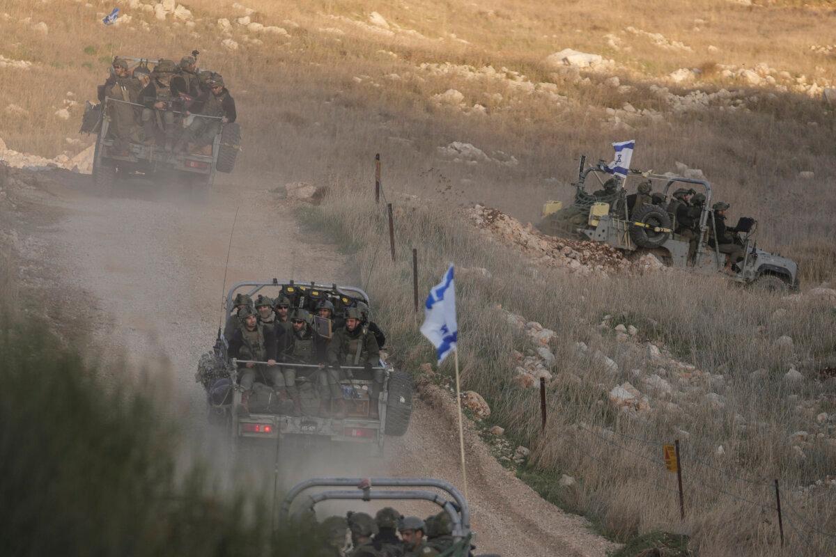 Israeli soldiers cross the security fence moving toward the line that separates the Israeli-annexed Golan Heights from Syria, in the town of Majdal Shams, on Dec. 15, 2024. (Matias Delacroix/AP)