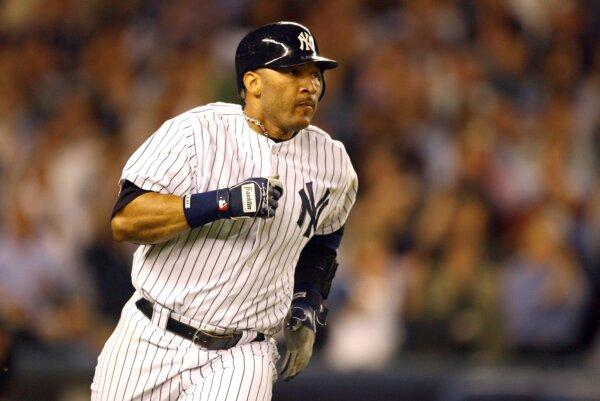Gary Sheffield of the New York Yankees runs after hitting a single against the Detroit Tigers in Game 1 of the American League Division Series at Yankee Stadium in New York on Oct. 3, 2006. (Al Bello/Getty Images)