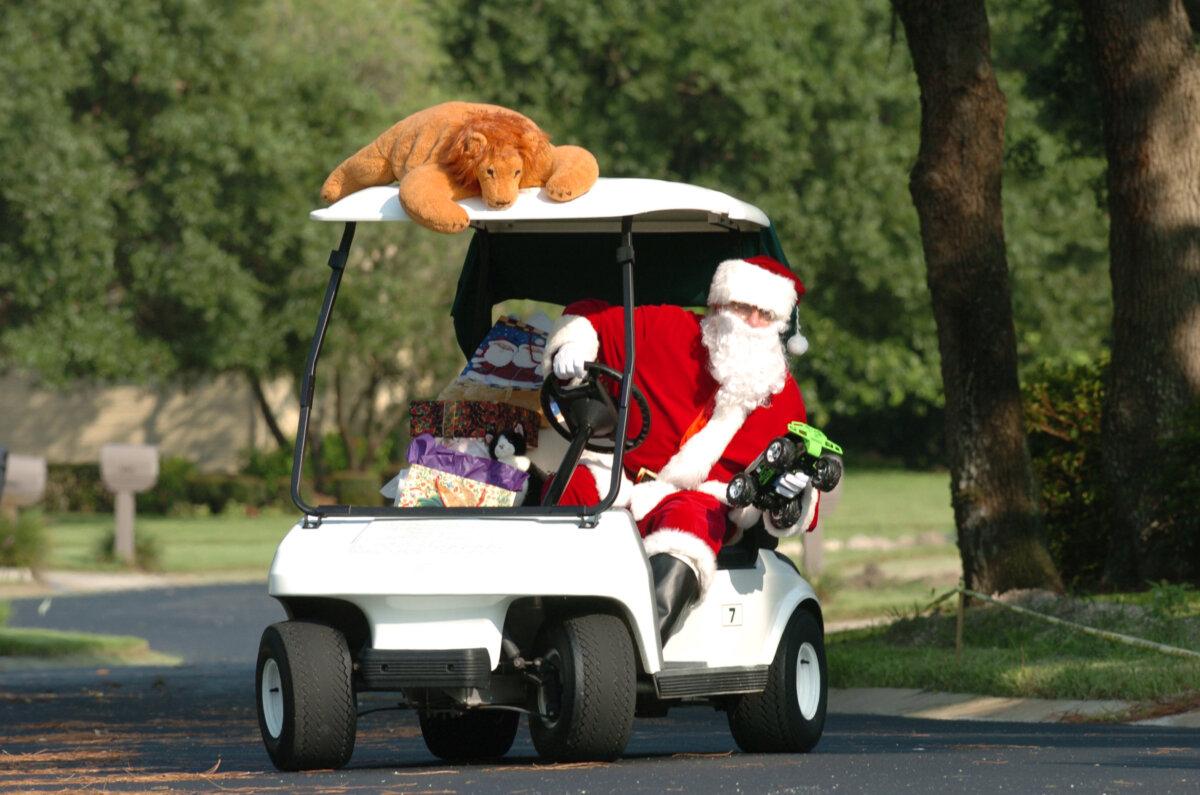 Santa trades his sleigh for a golf cart to deliver Christmas presents on Dec. 25, 2003. (Messerschmidt/Getty Images)