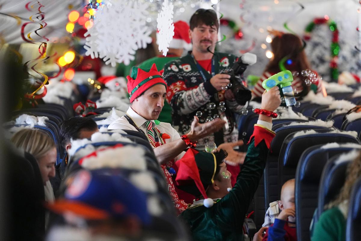 Flight Takes Children to Visit Santa at North Pole Scene in Transformed Denver Airport Hangar