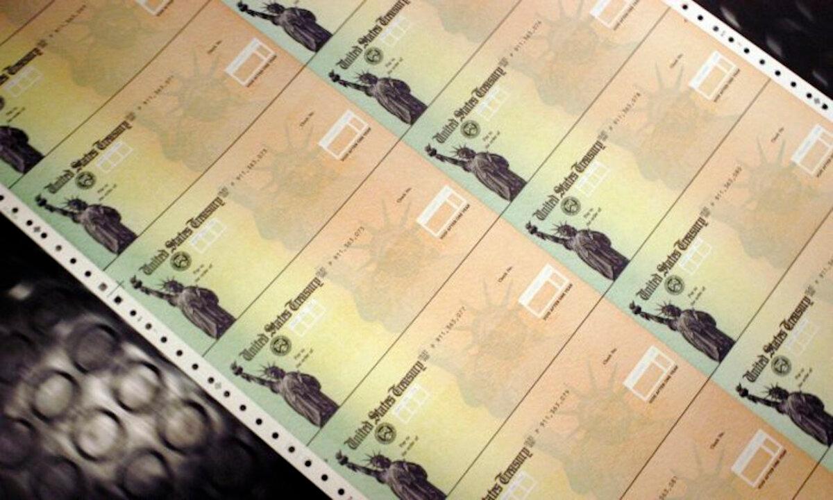 Blank Social Security checks are run through a printer at the US Treasury printing facility in Philadelphia, Pa., on July 18, 2011. (William Thomas Cain/Getty Images)
