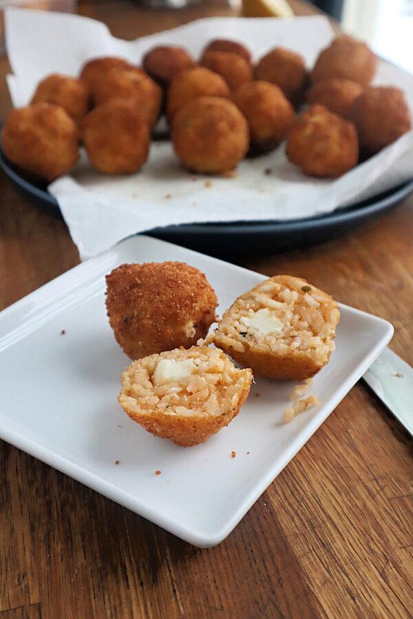 Deep-fried arancini are filled with herbs and spices, stuffed with mozzarella, breaded and fried until melty and golden. (Gretchen McKay/Pittsburgh Post-Gazette/TNS)