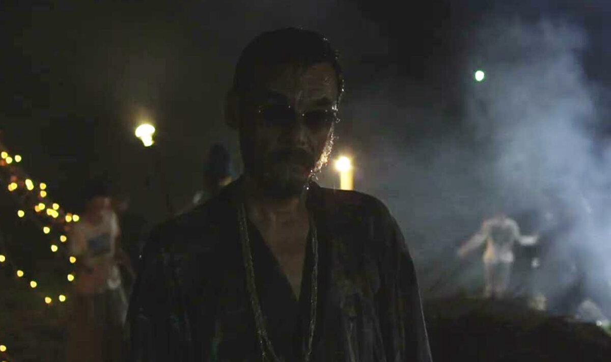 Tsuchiro (Takahiro Fujita) wears sunglasses at night, in “A Dobugawa Dream.” (GJW+)