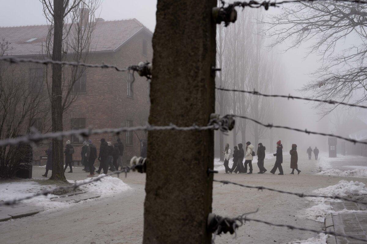 People visit the Memorial and Museum Auschwitz-Birkenau, a former Nazi German concentration and extermination camp, in Oswiecim, Poland, on Jan. 23. 2025. (AP Photo/Oded Balilty)