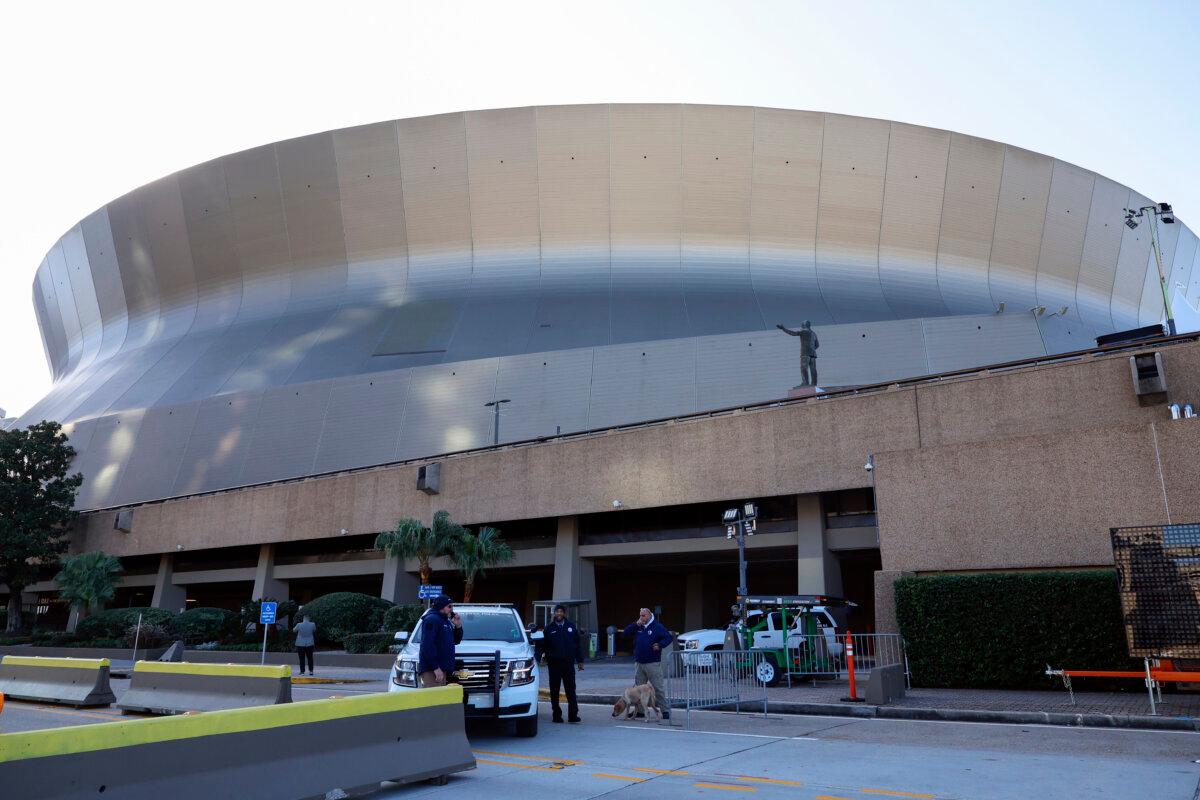 Security and bomb sniffing dogs check vehicles as they enter the Superdome parking garage ahead of the Sugar Bowl NCAA College Football Playoff game in New Orleans on Jan. 2, 2025. (Butch Dill/AP Photo)
