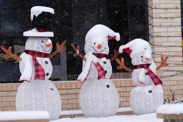 A layer of fresh snow tops holiday lawn characters outside a home as a winter storm sweeps over the intermountain West and across the country in Denver on Jan. 7, 2025. (David Zalubowski/AP Photo)