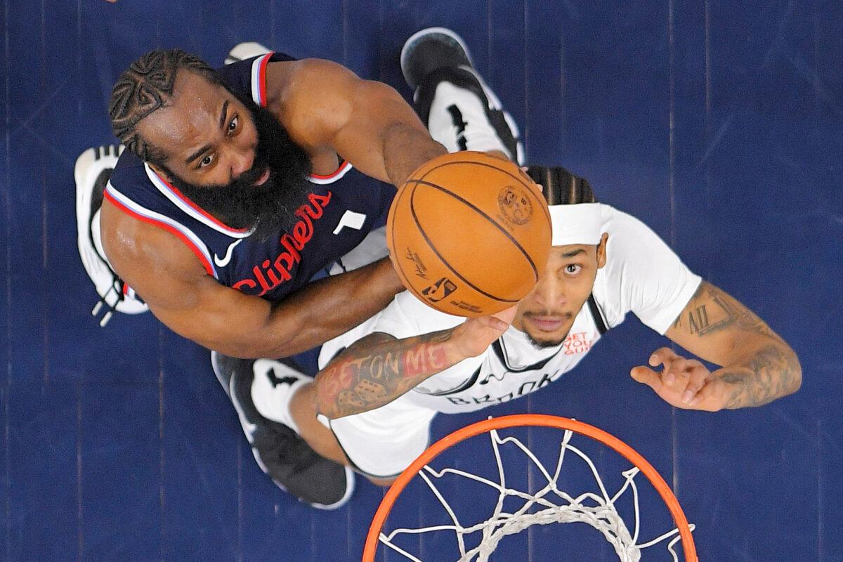 Los Angeles Clippers guard James Harden, left, and Brooklyn Nets guard Keon Johnson go after a rebound during the first half of an NBA basketball game, in Inglewood, Calif., Jan. 15, 2025. (Mark J. Terrill/AP Photo)