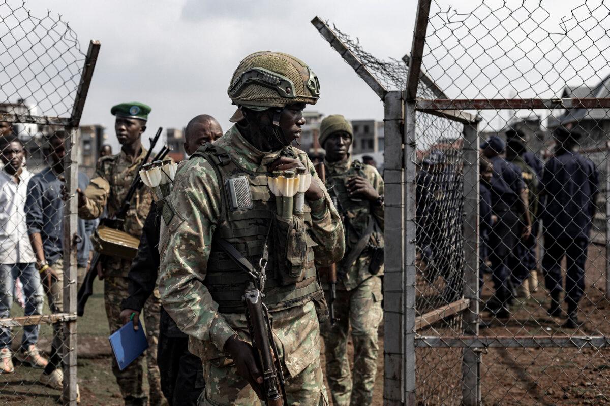 A member of the M23 movement looks on during an enrollment of civilians, police officers, and former members of the Armed Forces of the Democratic Republic of the Congo who allegedly decided to join the M23 movement voluntarily in Goma, Democratic Republic of the Congo, on Feb. 23, 2025. (Michel Lunanga/AFP via Getty Images)
